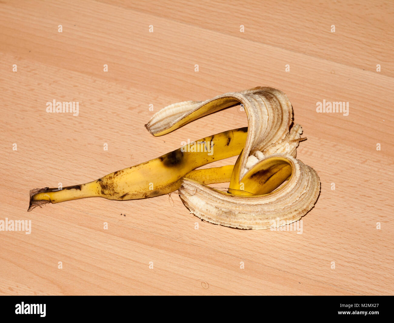 peeled banana skin on wooden laminate flooring danger hazard food