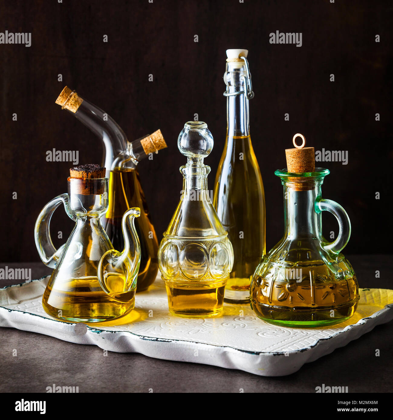 different shapes, types and sizes of cruets with olive oil on the table