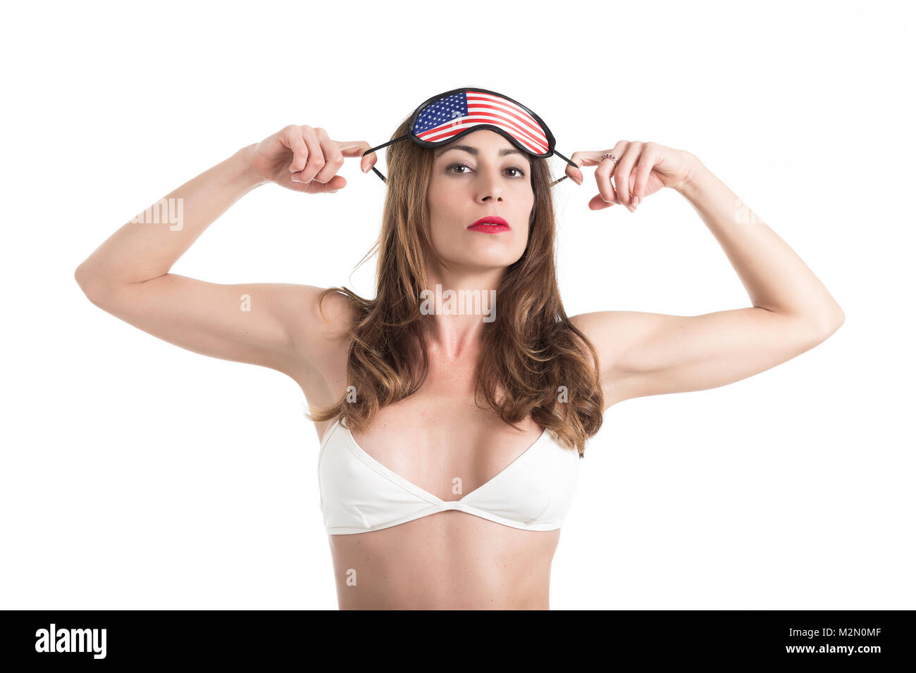 Young woman wearing eyemask. American Dream concept. Isolated on white background. Stock Photo