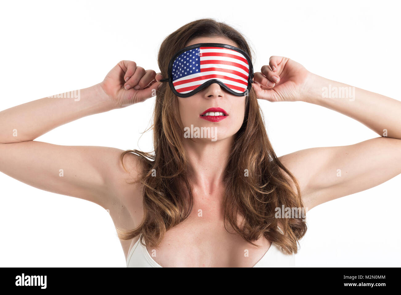 Young woman wearing eyemask. American Dream concept. Isolated on white background. Stock Photo