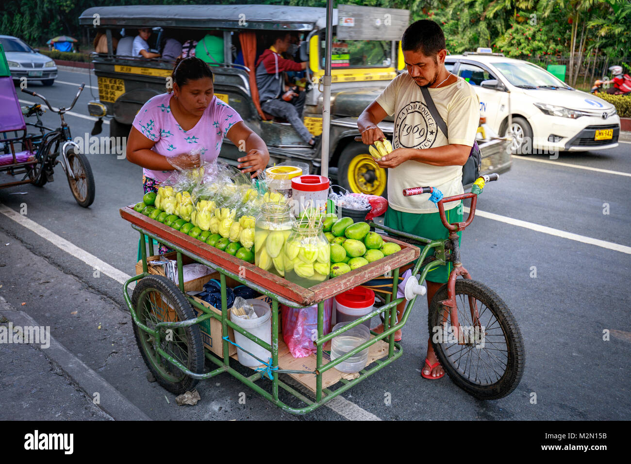 Manila, Philippines - Feb 4, 2018 : A street food vendor slices fresh