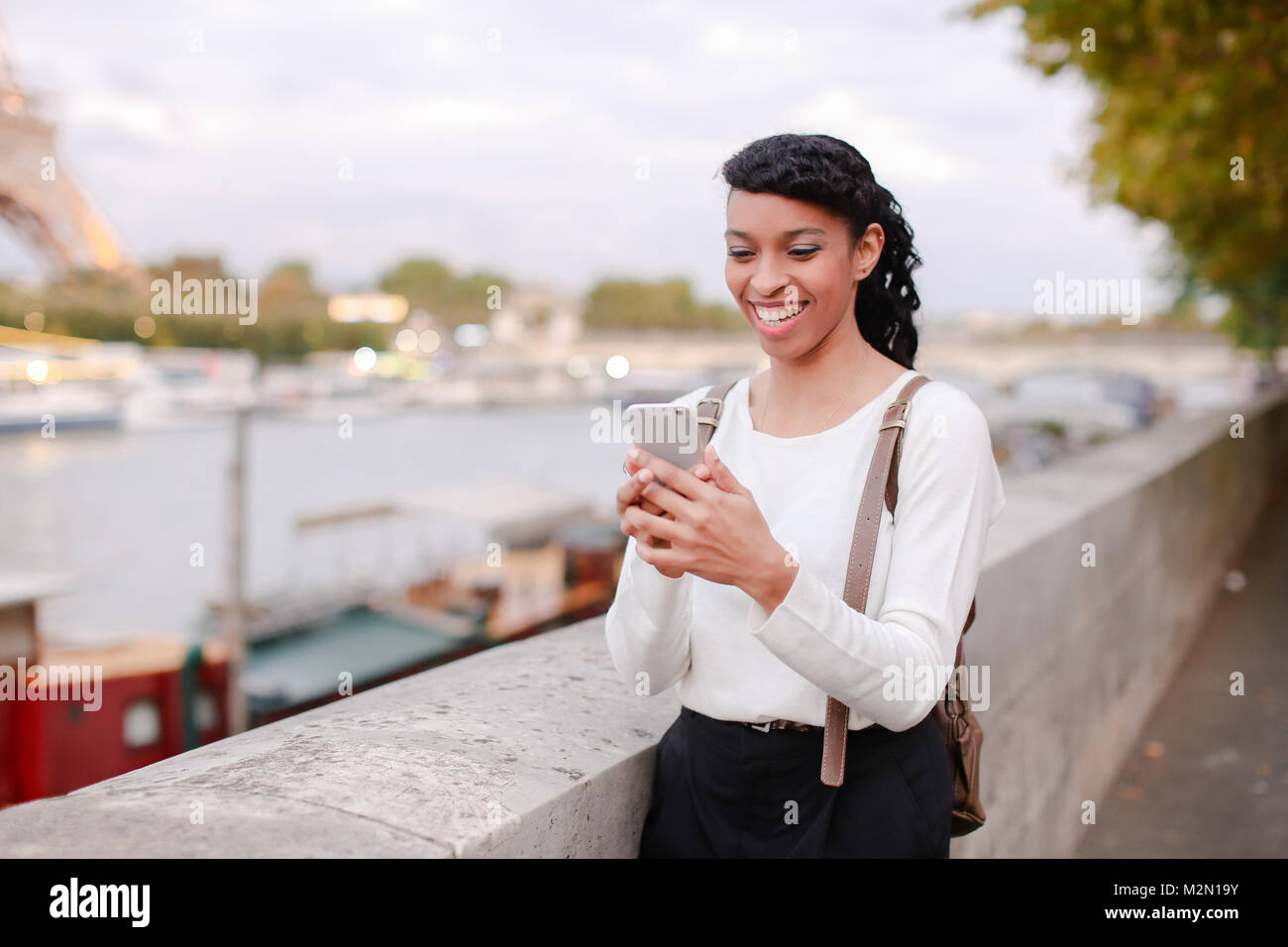 Model walking on street and shooting videos in breaks between ph Stock Photo