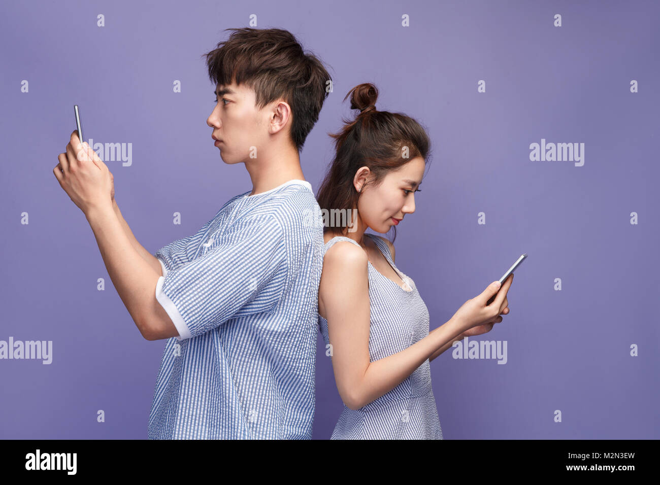 Young couples playing mobile phone Stock Photo