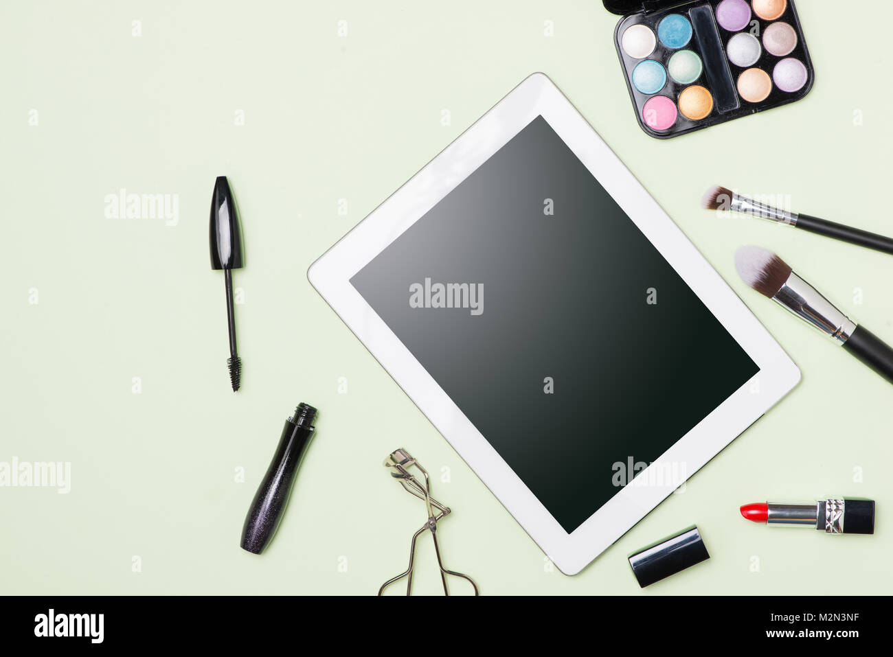 Flat lay of make up cosmetic products with digital tablet on light color background Stock Photo