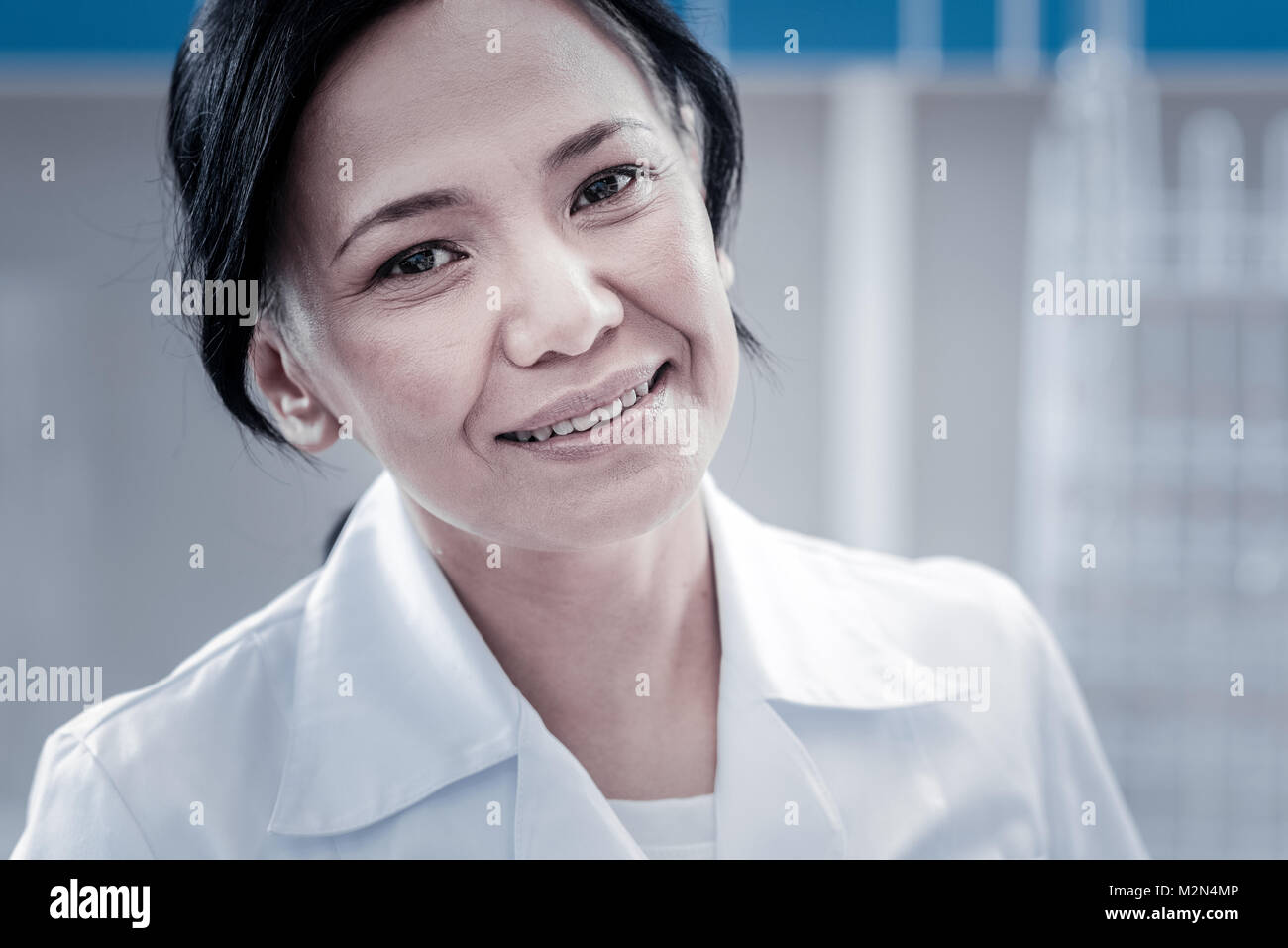 Portrait of charming female doctor smiling into camera Stock Photo