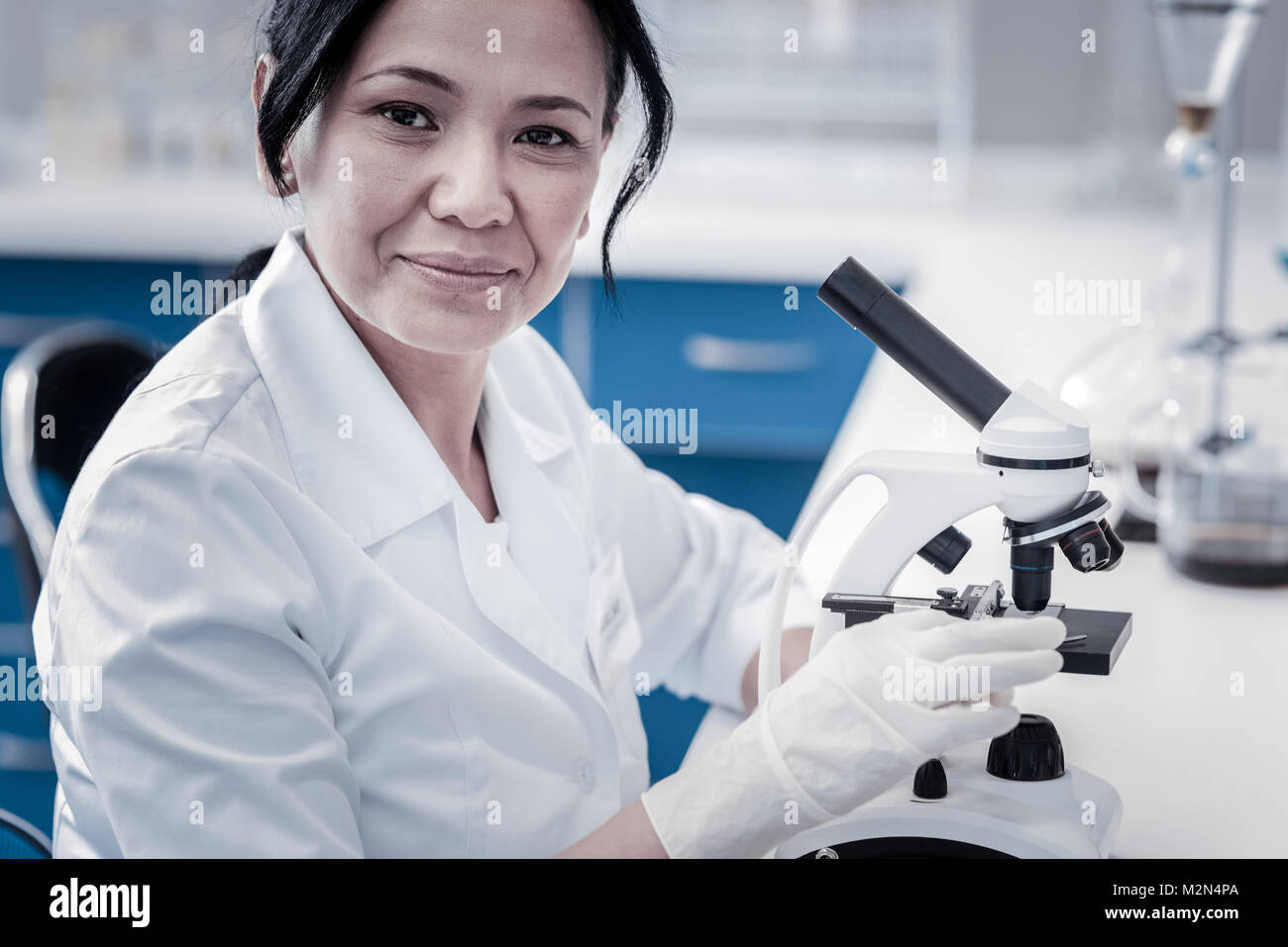Smiling mature lady posing for camera while working in laboratory Stock Photo