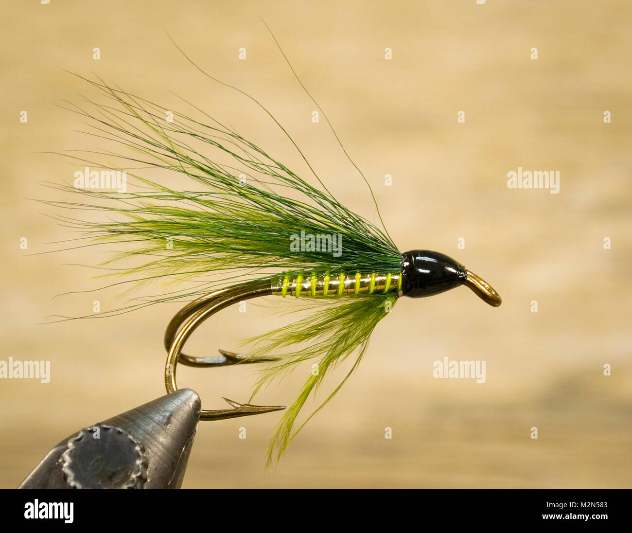 Green Bucktail Hairwing streamer Tied by Martin Battilana  Hook: Mustad-Double Fly ball-eye Bronzed #4 Body: goldtinsel Rib: lime green wire Throat: g Stock Photo