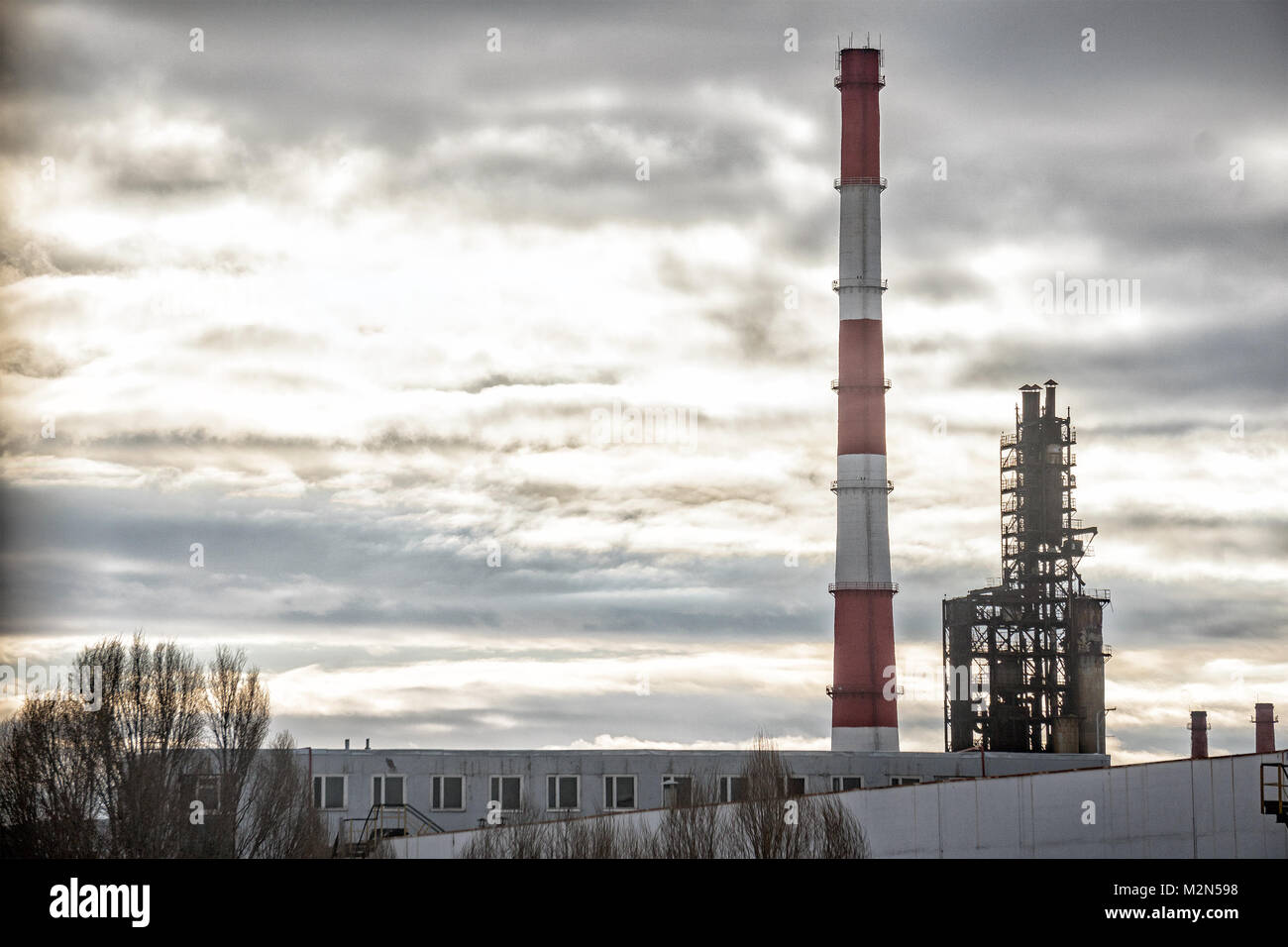 Tubes of factory on a background of the cloudy sky. Stock Photo