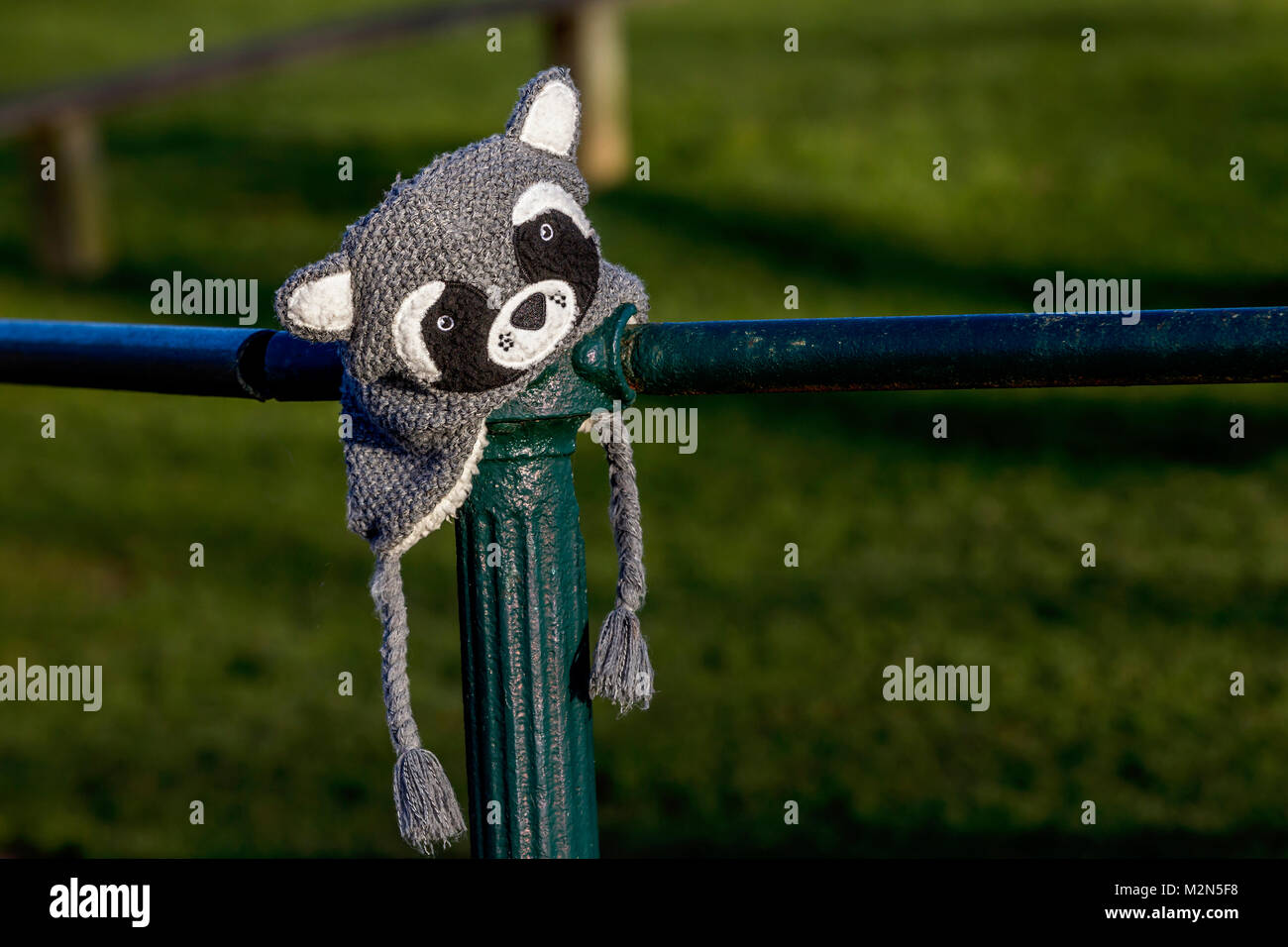 Forgotten hat put on metal fencing. Stock Photo