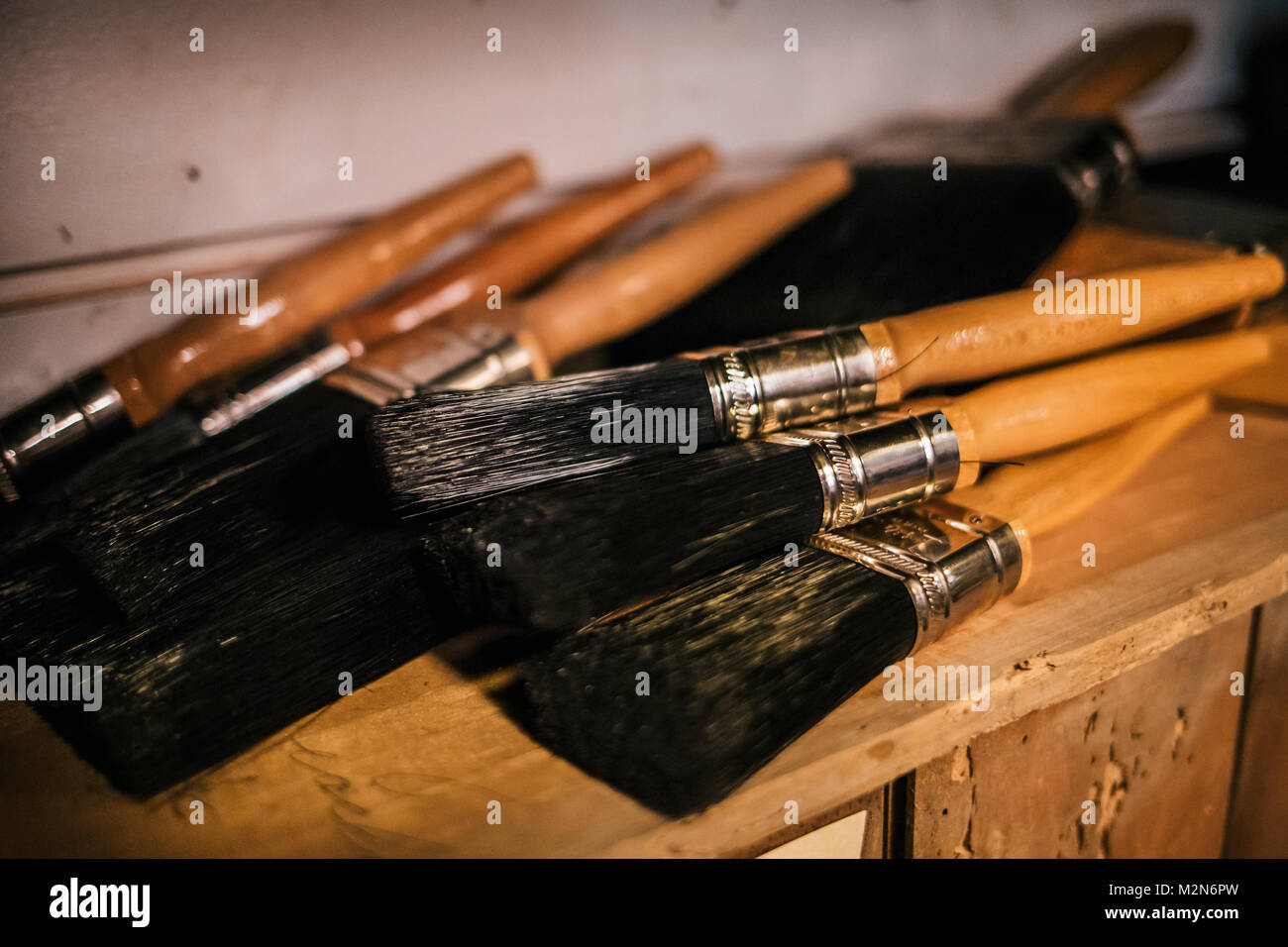 Several big black paint brushes on the shelf Stock Photo