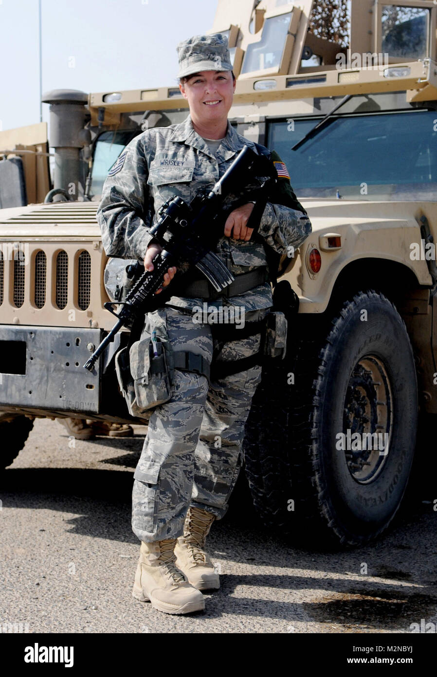 Tech. Sgt. Nicole Wrisley, 332nd Expeditionary Security Forces area  supervisor, stands in front of a Humvee tactical vehicle at Joint Base  Balad. Wrisley is deployed from Beale Air Force Base, Calif., and