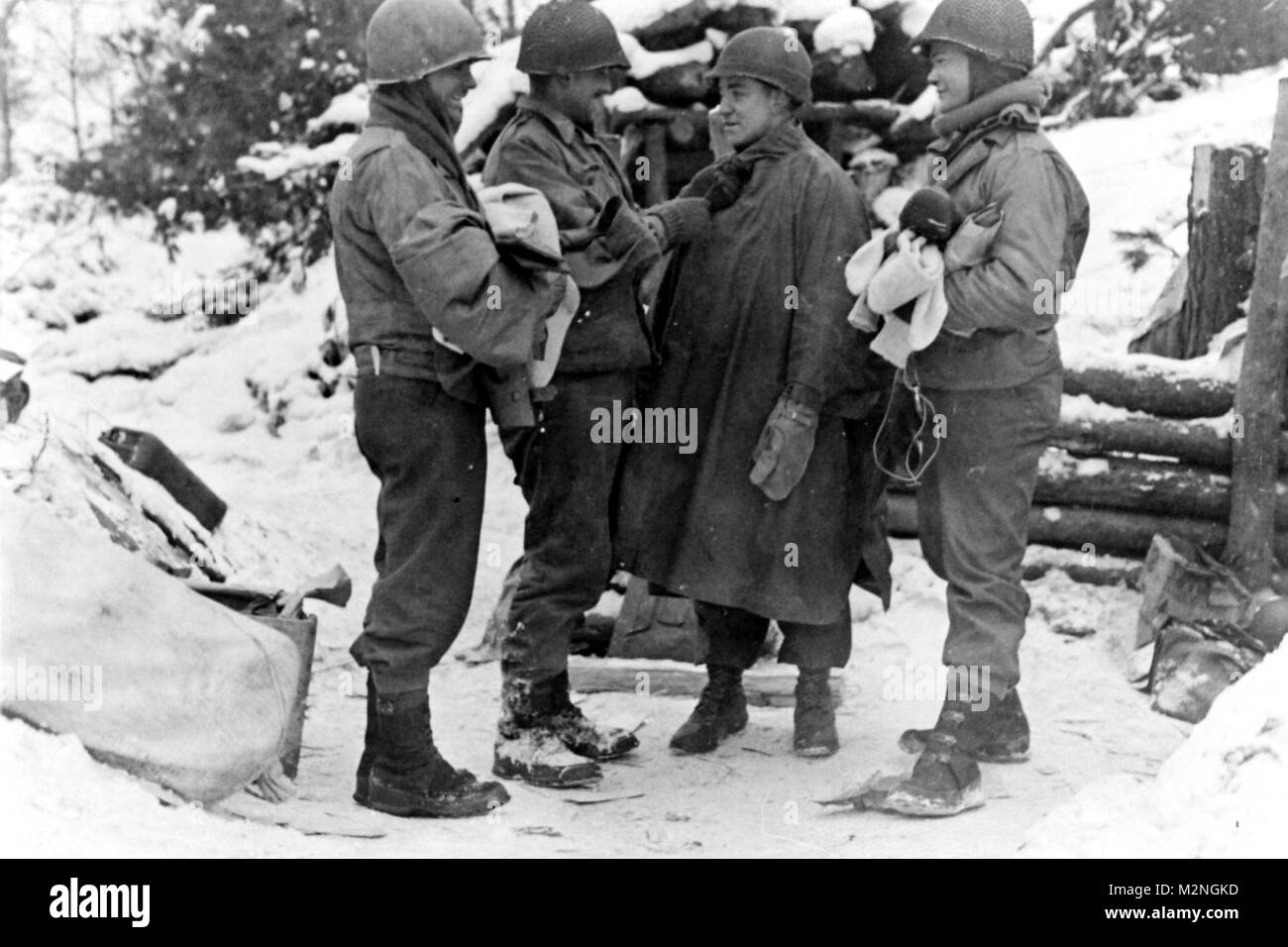 KLEINHAU, Germany, January 29, 1945 - Soldiers of the Company L, 3rd Battalion, 121st Infantry Regiment try on clothing during a lull in fighting in the Hurtgen Forest near the town of Kleinhau. Photo 327126, National Archives Records Administration (NARA), College Park, Md. Resupply by Georgia National Guard Stock Photo