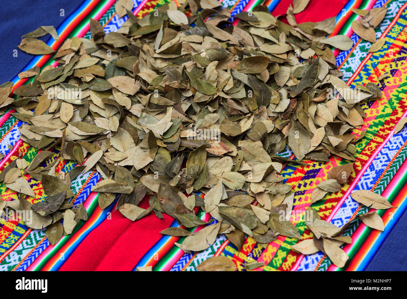 Coca leaves lying on South American fabrics, a remedy against high