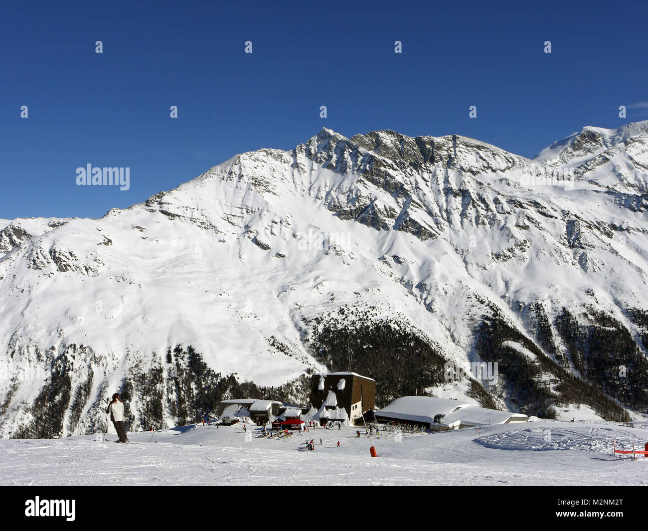 Winter scenes in the snowsports resort of Zinal in the Valais canton of Switzerland with a view to the middle station at Sorebois Stock Photo