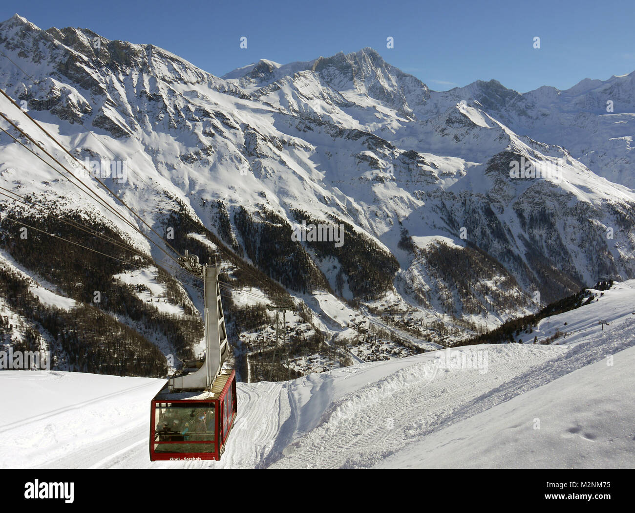 Winter scenes in the snowsports resort of Zinal in the Valais canton of Switzerland. Cable car from Zinal to the slopes at Sorebois Stock Photo