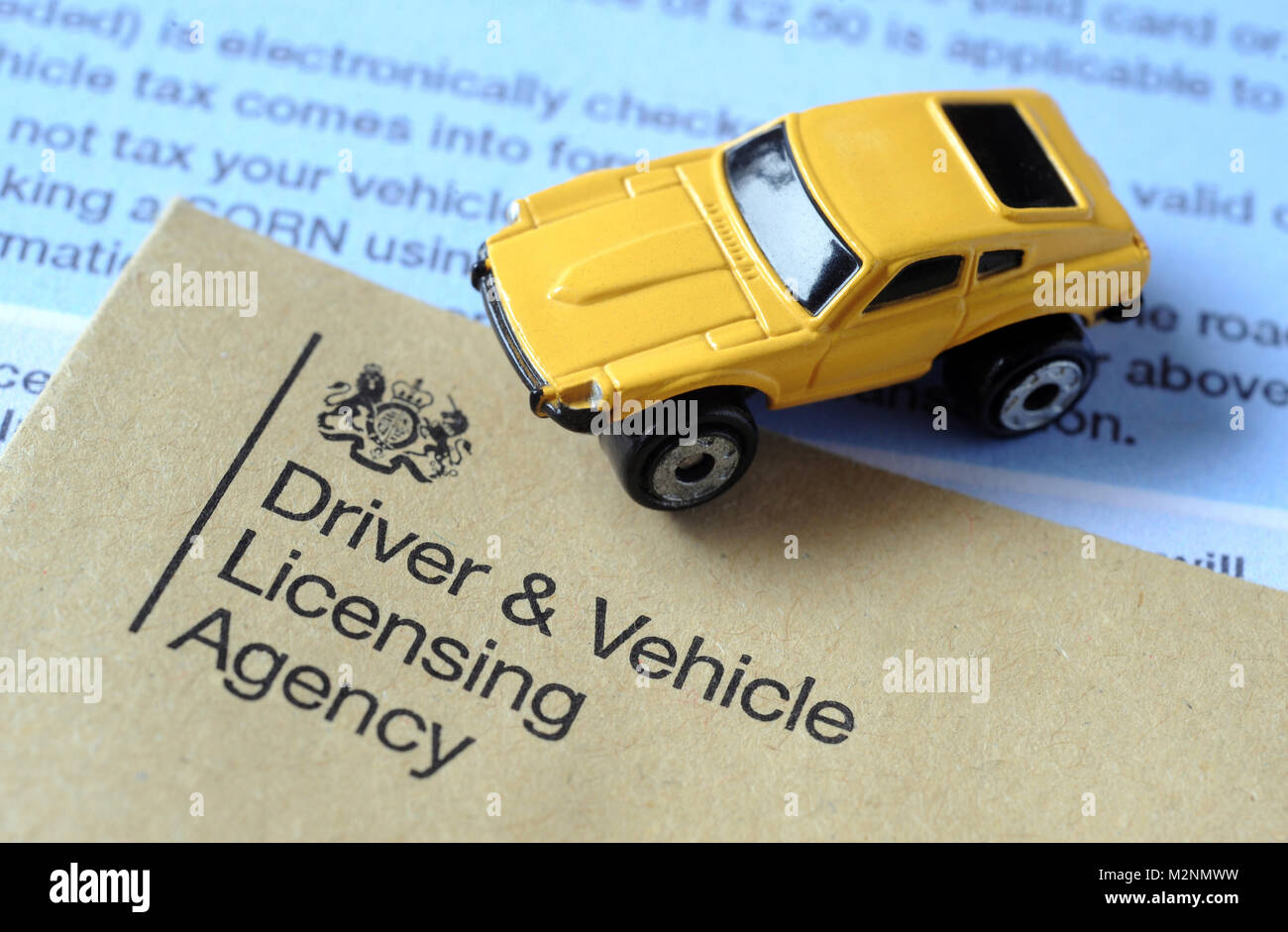 'DVLA'  LITERATURE AND LOGO WITH MODEL CAR RE DVLA DRIVER VEHICLE LICENSING AGENCY ROAD TAX EXCISE LICENSE MOTORISTS ETC Stock Photo