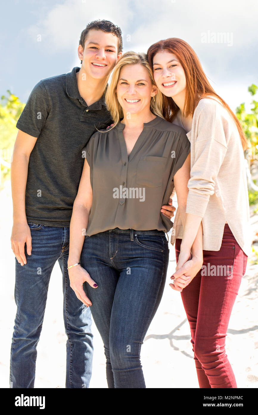 Latin mother and her teenage children. Stock Photo