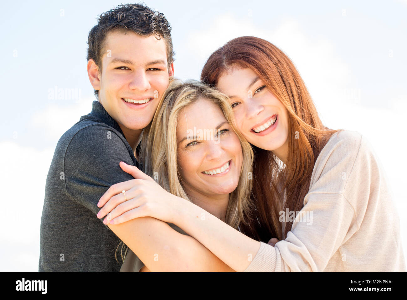 Latin mother and her teenage children. Stock Photo