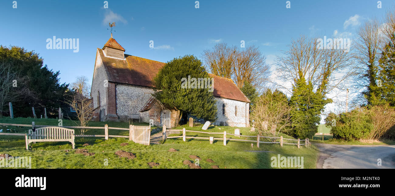St Peters Church and thatched village well. East Marden, West Sussex
