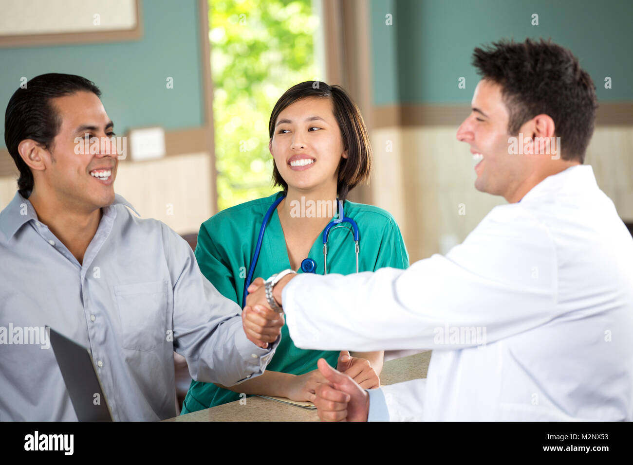 Medical team talking with patients. Stock Photo