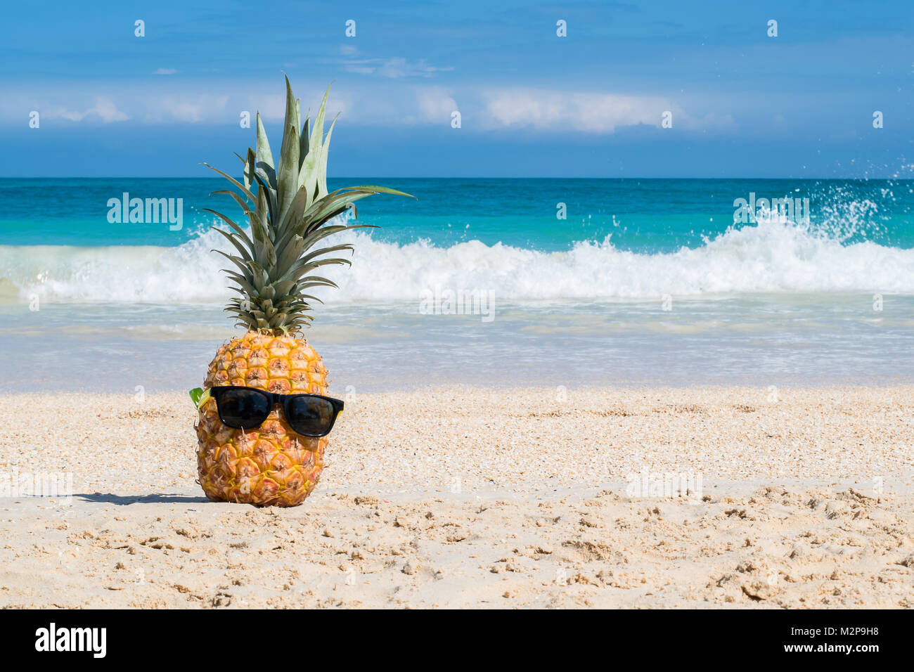 Hey girl, You a Fine-apple: Tropical pineapple chillin on a beach with sunglasses representing hawaiian vacation concept Stock Photo