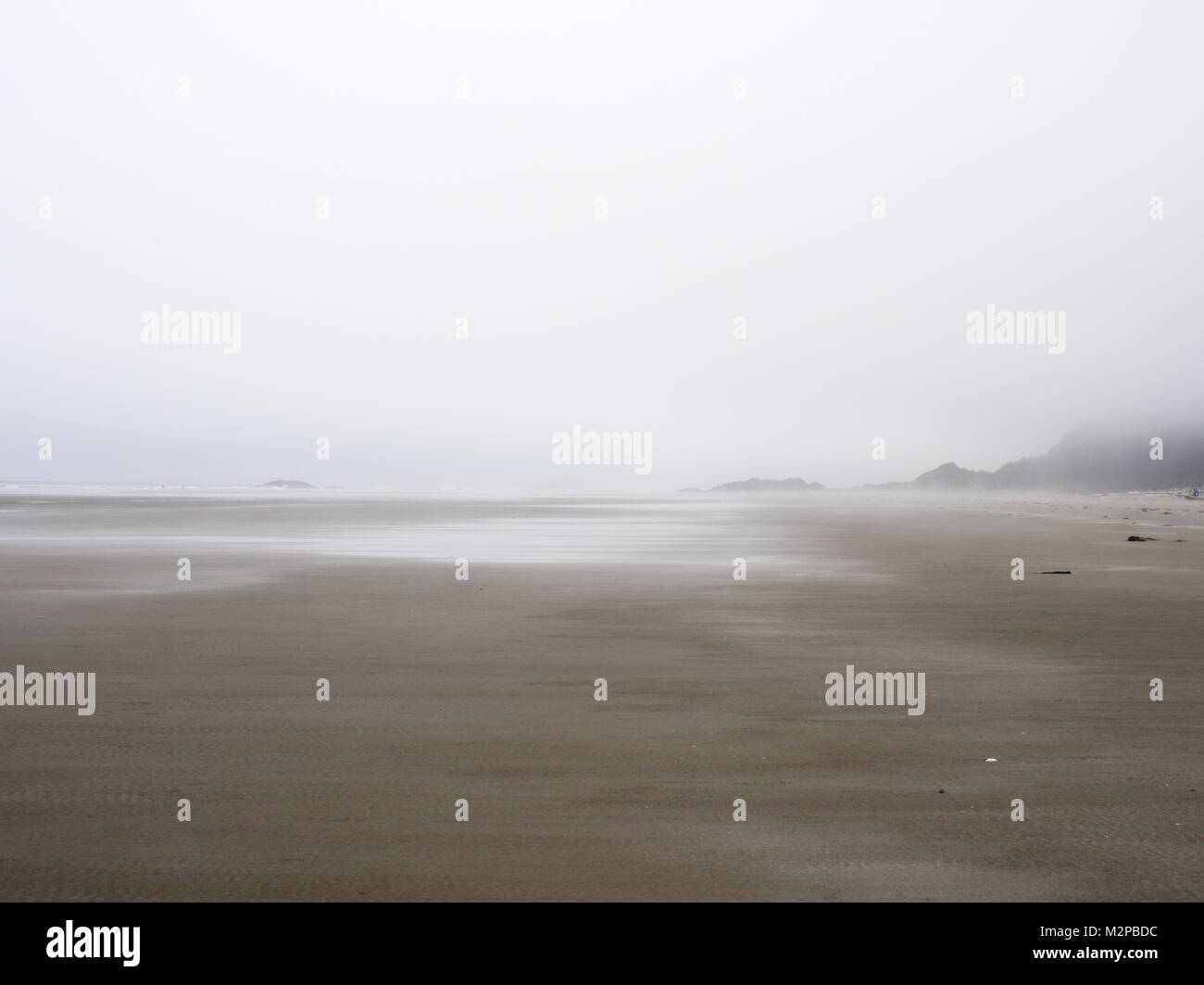 Tofino, Combers beach, in the fog - June 30/2017 - looking north.  Thick fog blends the ocean to the sky. Stock Photo