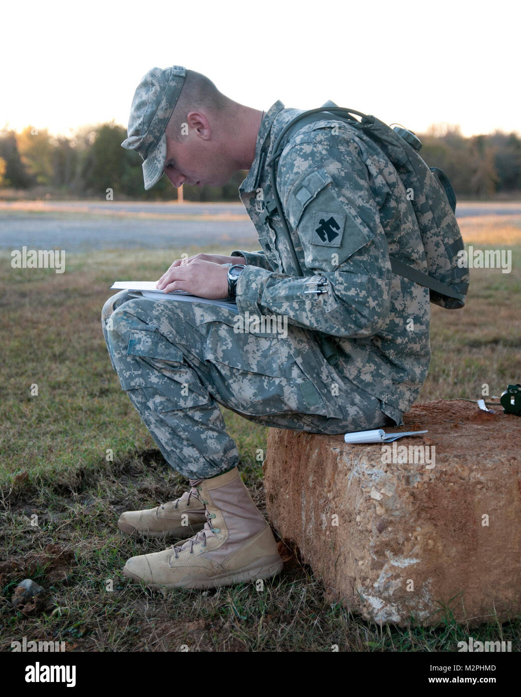 A member of the Oklahoma Army National Guard plots out points on a land