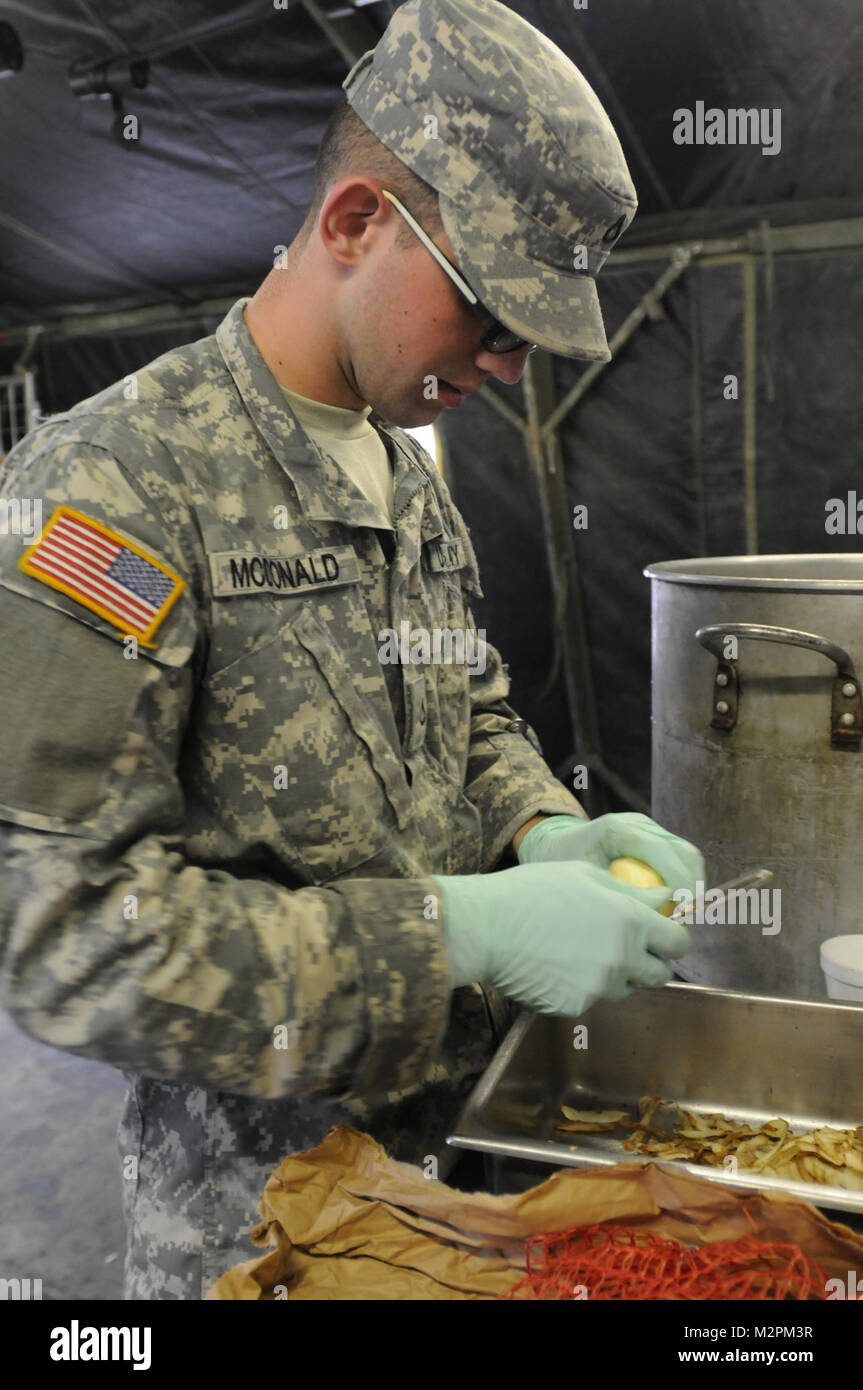Pfc. Nicholas McDonald from the 444th Minimal Care Detachment peels potatoes for the 452nd Combat Support Hospital during the U.S. Army Reserve's Connelly Competition at Fort McCoy, Wis., on April 9.  (Photo by Maj. Matt Lawrence, 807th MDSC Public Affairs) 20110409-DSC 2732 by 807MCDS Stock Photo