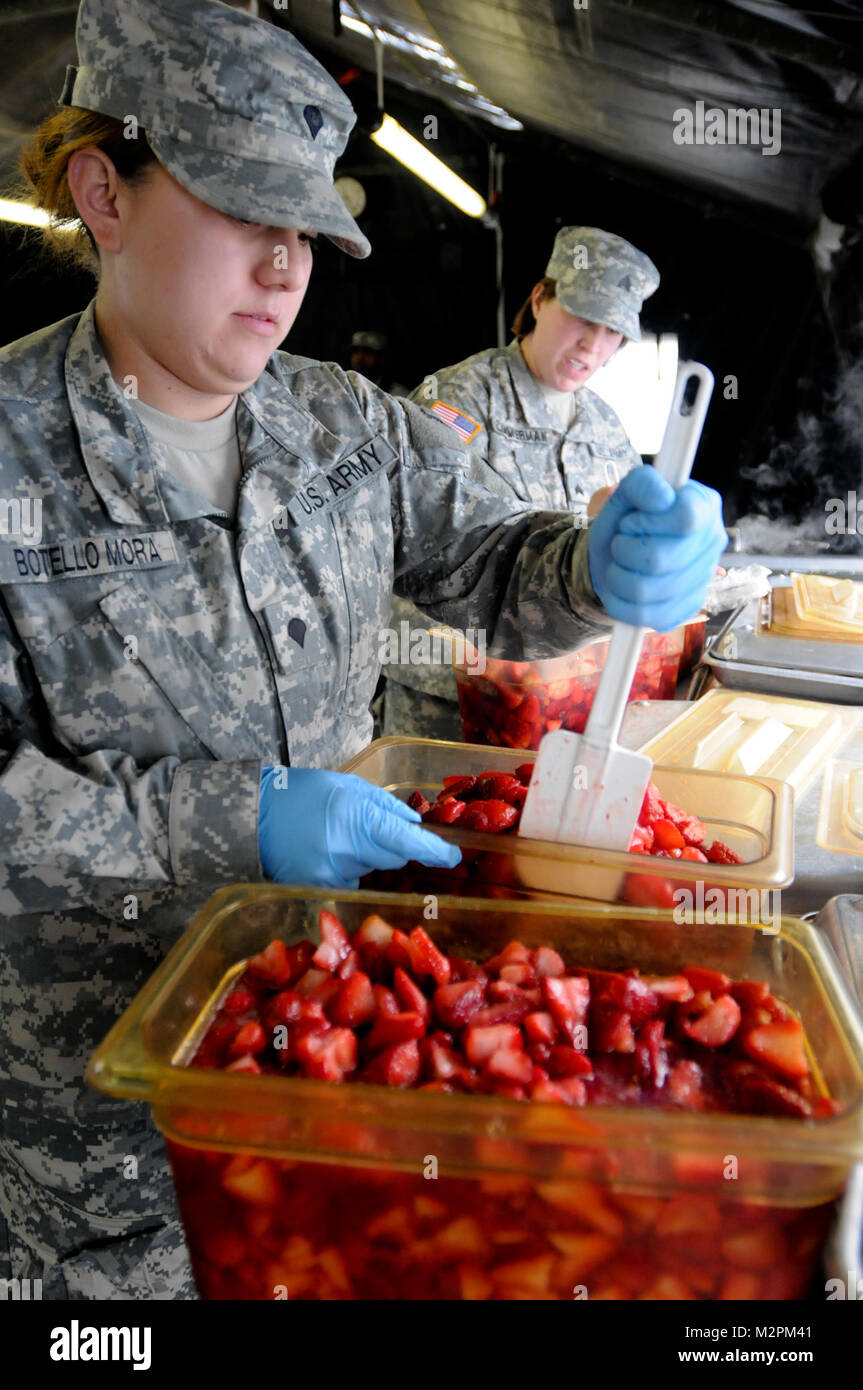 Spc. Jessica Botello-Mora of the 452nd Combat Support Hospital stirs a sugar mix into strawberries at the U.S. Army Reserve's Connelly Competition at Fort McCoy, Wis., on April 9.  (Photo by Maj. Matt Lawrence, 807th MDSC Public Affairs). 20110409-DSC 2825 by 807MCDS Stock Photo