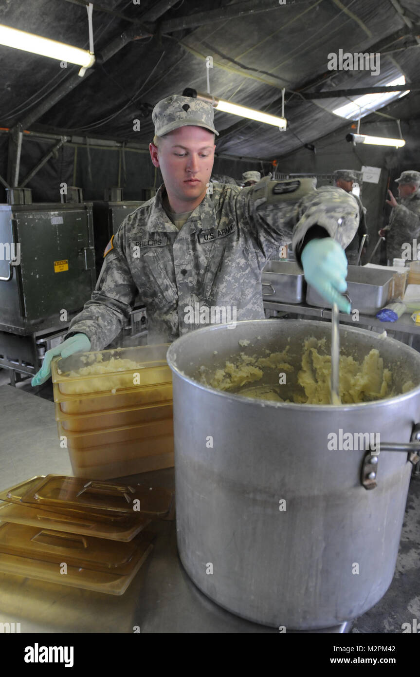 Spc. John Phillips of Alpha Company, 452nd Combat Support Hospital prepares mashed potatoes for serving at the U.S. Army Reserve's Connelly Competition at Fort McCoy, Wis., on April 9.  (Photo by Maj. Matt Lawrence, 807th MDSC Public Affairs). 20110409-DSC 2852 by 807MCDS Stock Photo