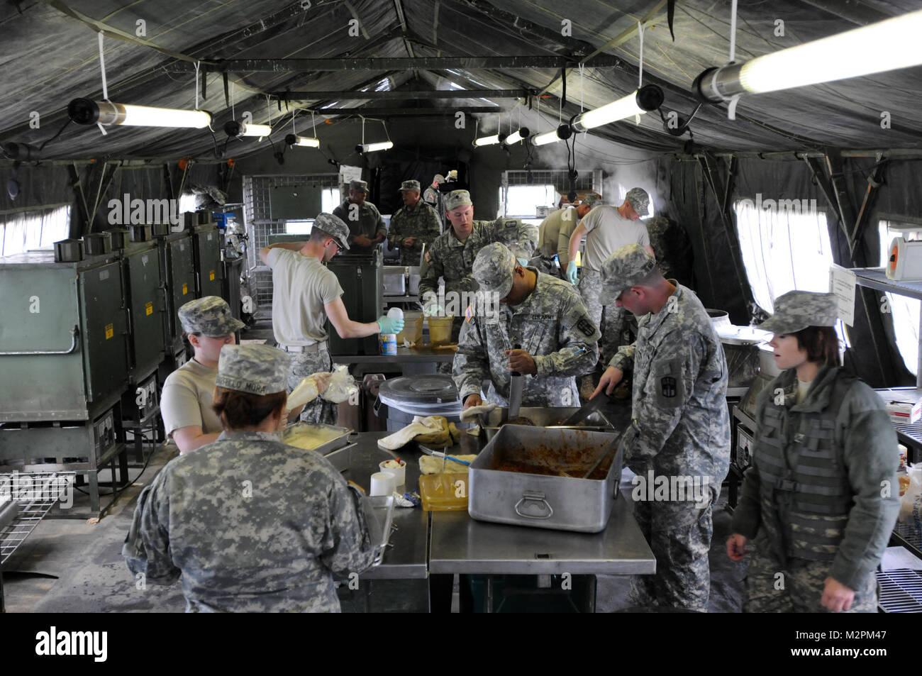 Soldiers feverishly prepare food in the  field kitchen of the 452nd Combat Support Hospital during the U.S. Army Reserve's Connelly Competition at Fort McCoy, Wis., on April 9.  (Photo by Maj. Matt Lawrence, 807th MDSC Public Affairs) 20110409-DSC 2885 by 807MCDS Stock Photo