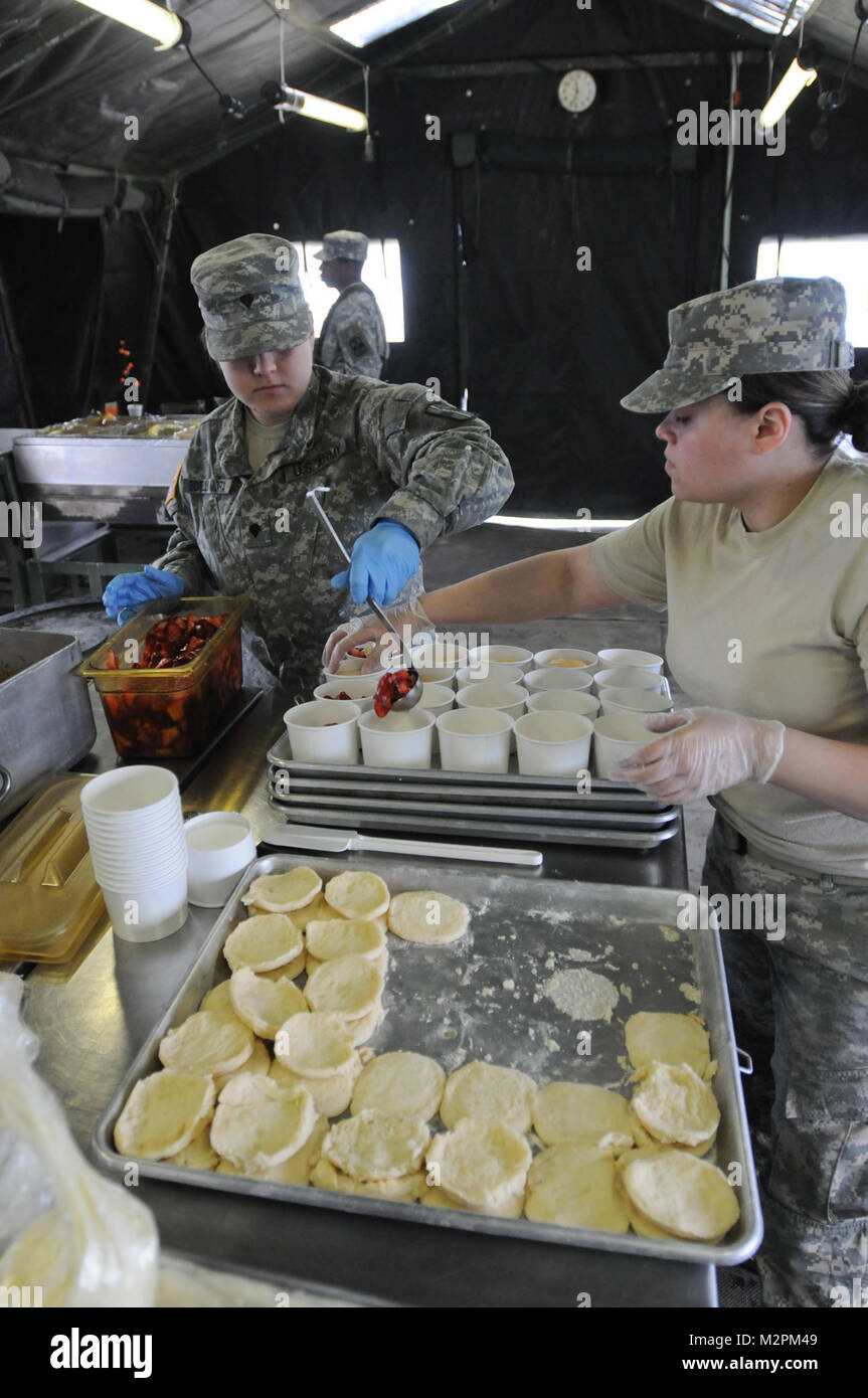 Spc. Jessica Botello-Mora and Spc. Isis Salgado of the 452nd Combat Support Hospital assemble strawberry shortcake at the U.S. Army Reserve's Connelly Competition at Fort McCoy, Wis., on April 9.  (Photo by Maj. Matt Lawrence, 807th MDSC Public Affairs). 20110409-DSC 2919 by 807MCDS Stock Photo
