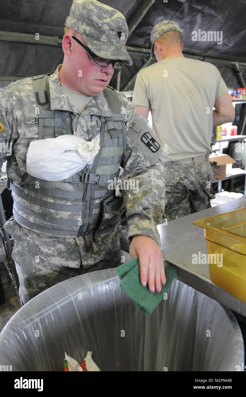 Spc. Scott Brunn of Bravo Company, 452nd Combat Support Hospital, cleans the cooking surfaces at the U.S. Army Reserve's Connelly Competition at Fort McCoy, Wis., on April 9.  (Photo by Maj. Matt Lawrence, 807th MDSC Public Affairs). 20110409-DSC 2942 by 807MCDS Stock Photo