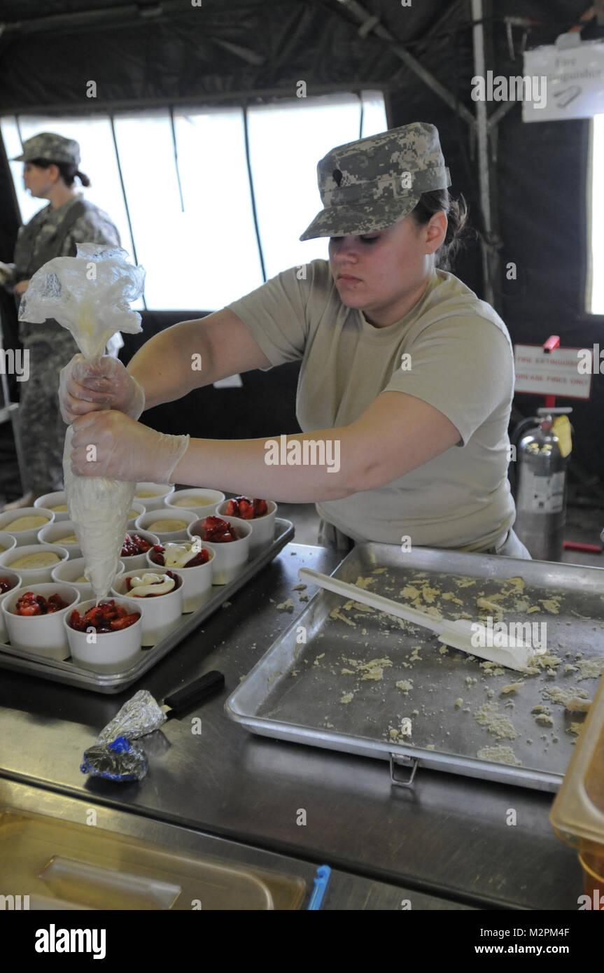 Spc. Isis Salgado of the 452nd Combat Support Hospital assembles strawberry shortcake at the U.S. Army Reserve's Connelly Competition at Fort McCoy, Wis., on April 9.  (Photo by Maj. Matt Lawrence, 807th MDSC Public Affairs). 20110409-DSC 2948 by 807MCDS Stock Photo