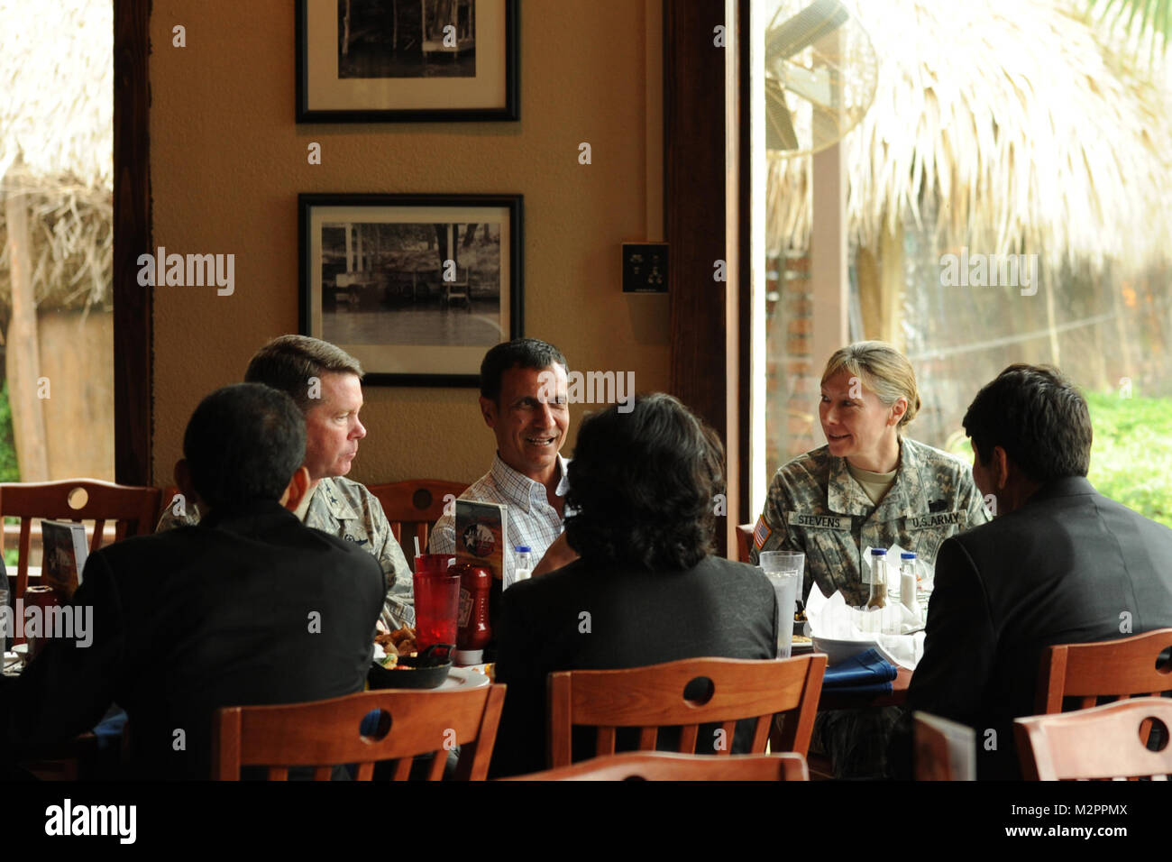 On May 2nd 2011, in Austin, Texas, Major General John F. Nichols, the Adjutant General of the Texas Military Forces and Brigadier General Joyce L. Stevens the Assistant Adjutant General of the Texas Military Forces, has lunch with the Afghanistan delegation to Texas.  The Afghanistan delegation is here to discuss continued partnership opportunities with their country. The delegation consists of Afghan representatives from provincial and district levels of government, the University of Ghazni, and a representative from Afghan media, Tolo TV.(U.S. Air Force photo by Staff Sgt. Eric Wilson) 11050 Stock Photo