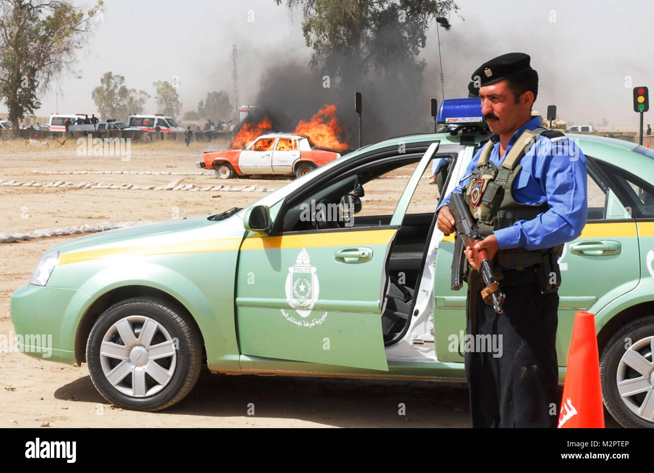 Safe Distance CONTINGENCY OPERATING SITE WARRIOR, Iraq – An Iraqi Policeman establishes a perimeter while waiting for fire department responders to control a simulated vehicle-borne improvised explosive device during an emergency response exercise at the Kirkuk Training Center, May 29, 2011. Iraqi Security Forces conducted the ERE as part of Operation Iron Lion, a set of events, missions and exercises demonstrating various ISF agencies’ self-sufficiency, interoperability and adaptability to establish internal security and defend against external threats. (U.S. Army photo by Staff Sgt. Robert D Stock Photo