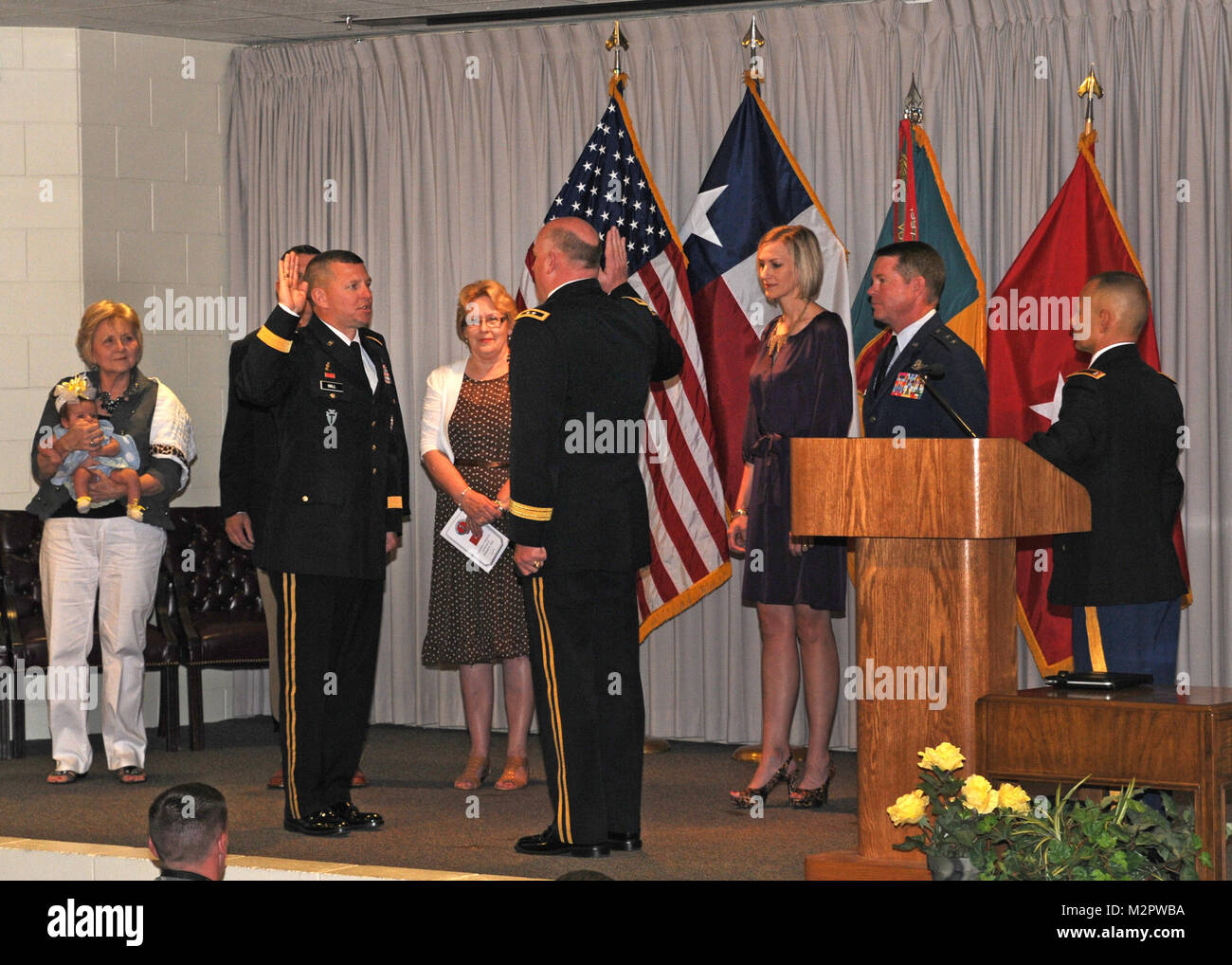 William A. Hall of Round Rock, Texas, is promoted to rank of Brigadier General in the Texas Army National Guard, and is surrounding by family while he is adminstered the oath of office by Maj. Gen. James K. 'Red' Brown, commanding general of the Texas Army National Guard's 36th Infantry Division, during a ceremony at Camp Mabry, in Austin, Texas, on June 9, 2012. Brig. Gen. Hall is the commanding general of the Texas Army National Guard's 136th Maneuver Enhancement Brigade (MEB), based in Round Rock, Texas. (National Guard photo by Staff Sgt. Phil Fountain / Released) BG Hall Promotion by Texa Stock Photo