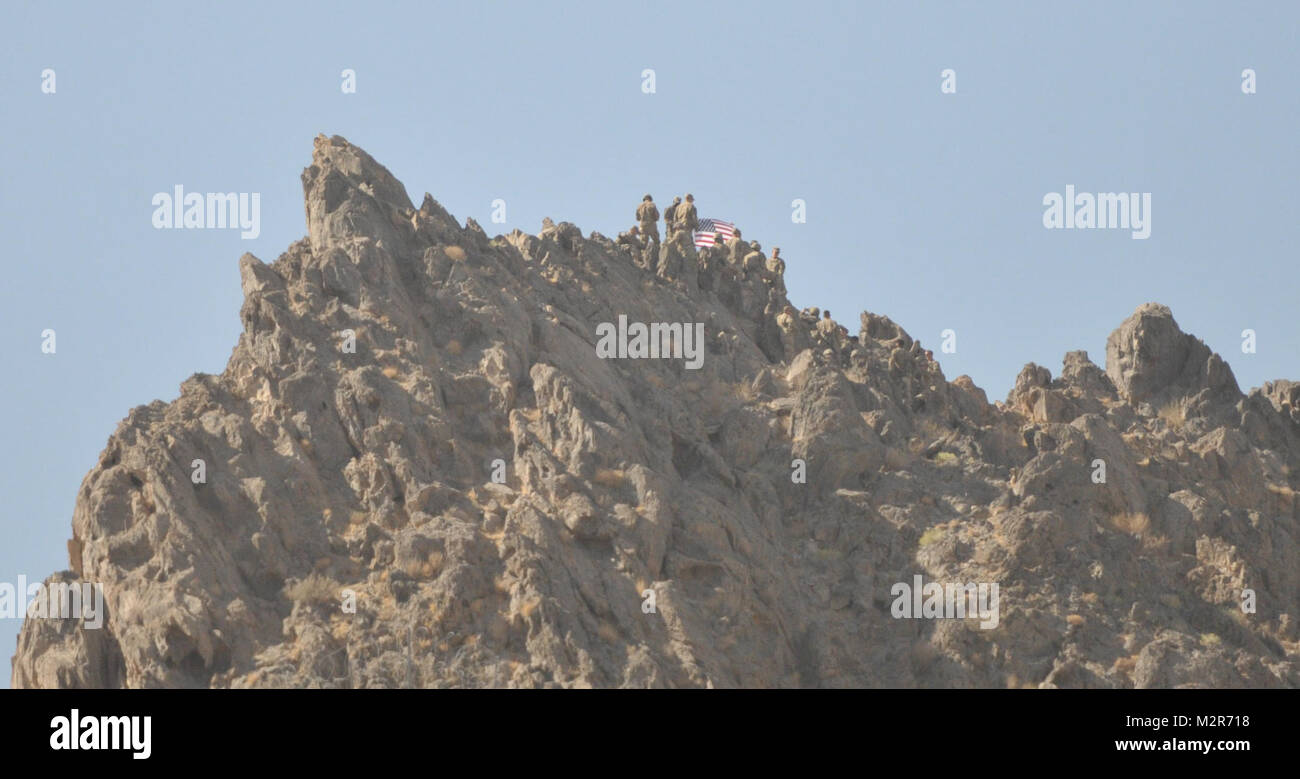 Soldiers from the 1st Stryker Brigade Combat Team, 25th Infantry Division climb to the top of the mountain surrounding Forward Operating Base Masum Ghar for a reenlistment/promotion ceremony on 2 October. U.S. Army Photo by Pfc. Andrew Geisler, 1/25 SBCT Public Affairs 111002-A-9186G-011 by 1 Stryker Brigade Combat Team Arctic Wolves Stock Photo