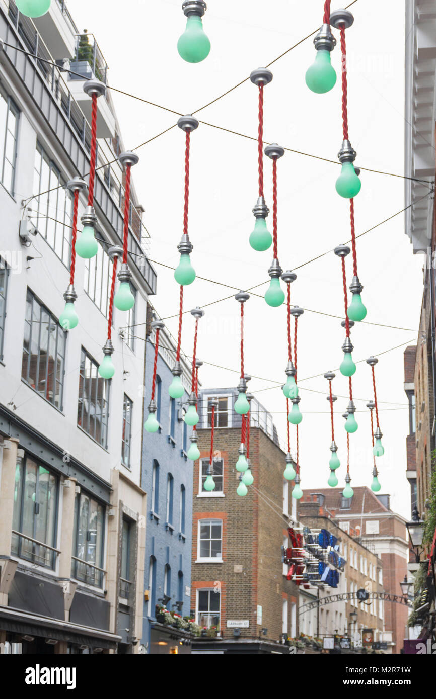 Green light bulbs decorate a shopping street in london hires stock