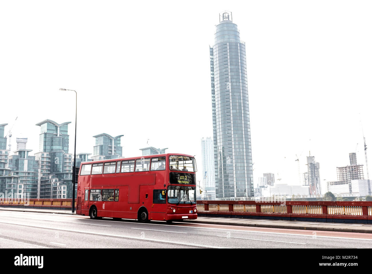 A red double-decker bus on a bridge in London Stock Photo