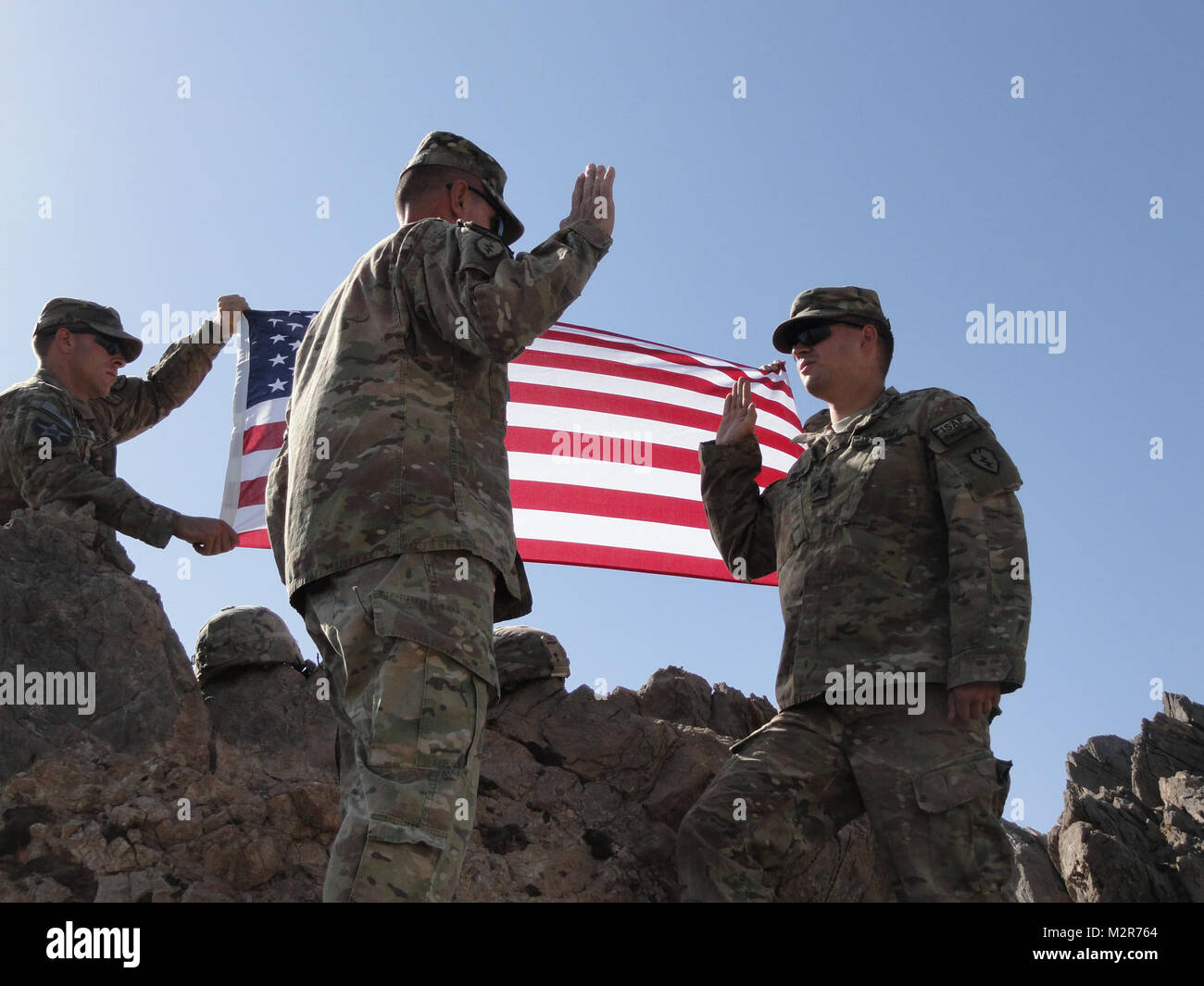 Col. Todd Wood, Commander of the 1st Stryker Brigade Combat Team, 25th Infantry Division, reenlists Cpl. Wiley Pritchett, an infantryman with the 1/25 SBCT Tactical Assault Command, in a ceremony at the top of the mountain above Forward Operating Base Masum Ghar on 2 September. U.S. Army photo by Sgt. 1st Class Melanie Currasco 1/25 SBCT Communications Shop 111002-A-3728C-005 by 1 Stryker Brigade Combat Team Arctic Wolves Stock Photo
