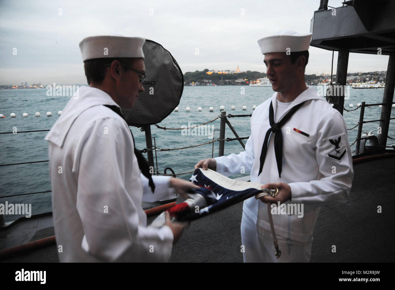 111014-N-RB564-011: ISTANBUL, Turkey (Oct. 14, 2011) — Seaman Apprentice Stephen Carr and Cryptologic Technician (Technical) 3rd Class Jacob Blackwell fold the U. S. flag following evening colors aboard the guided-missile cruiser USS Philippine Sea (CG 58) while in port Istanbul, during a four-day port visit. Philippine Sea is on a regularly scheduled deployment in the Black Sea and serves to promote peace and security in the U.S. 6th Fleet area of responsibility. (U.S. Navy photo by Mass Communication Specialist 2nd Class Gary Prill/Released) 111014-N-RB564-011 by EUCOM Stock Photo