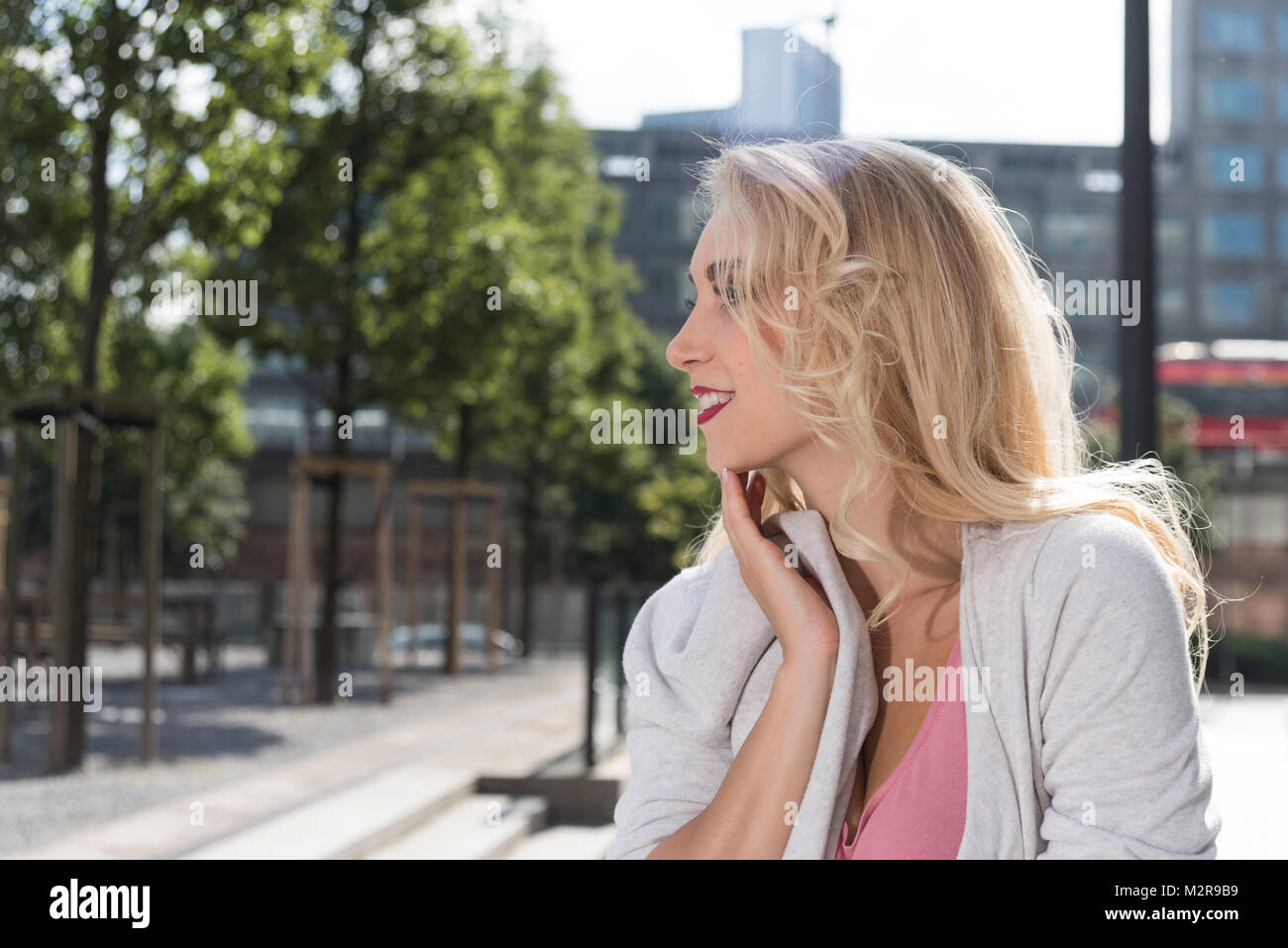 Young woman in the town, smile, portrait, sidewise Stock Photo