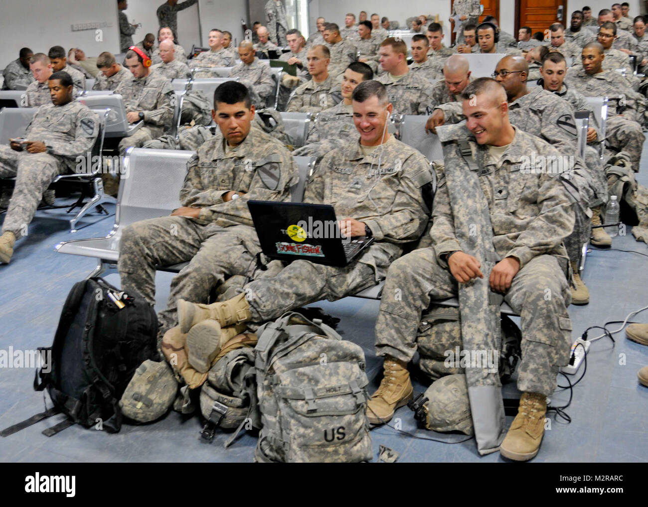 Soldiers with the 3rd Brigade Combat Team, 8th Cavalry Regiment, pass the time before their flight at a terminal on Contingency Operating Base Adder Oct. 26. Waiting service members have access to wireless Internet and a supply of cold water. The 3rd BCT, who deployed to Iraq to support Operation New Dawn in February, oversaw the closing of Garry Owen before coming to COB Adder to redeploy. At the Terminal by United States Forces - Iraq (Inactive) Stock Photo