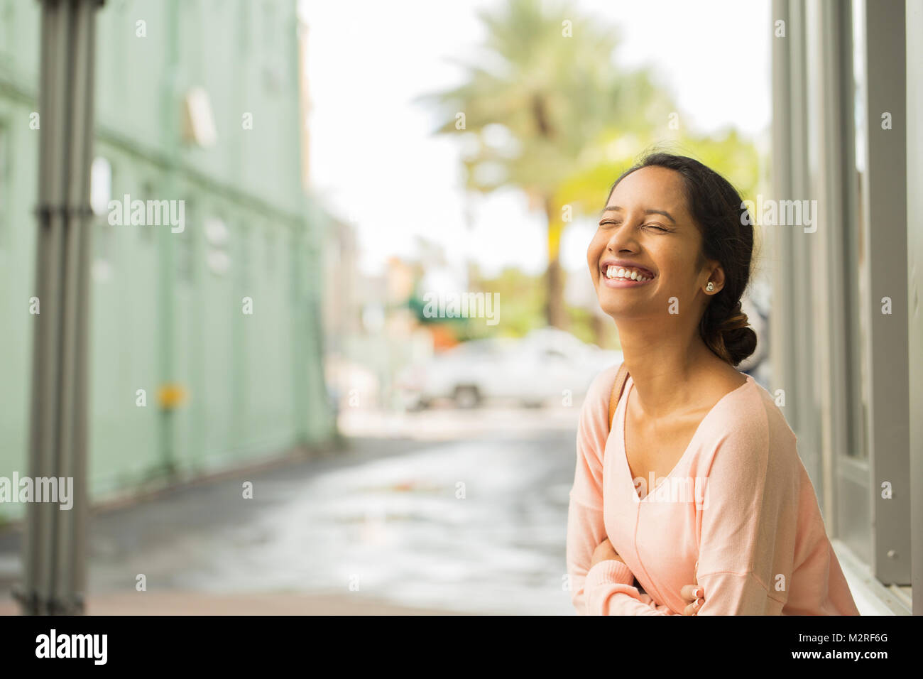 Hispanic young woman laughing hi-res stock photography and images - Alamy