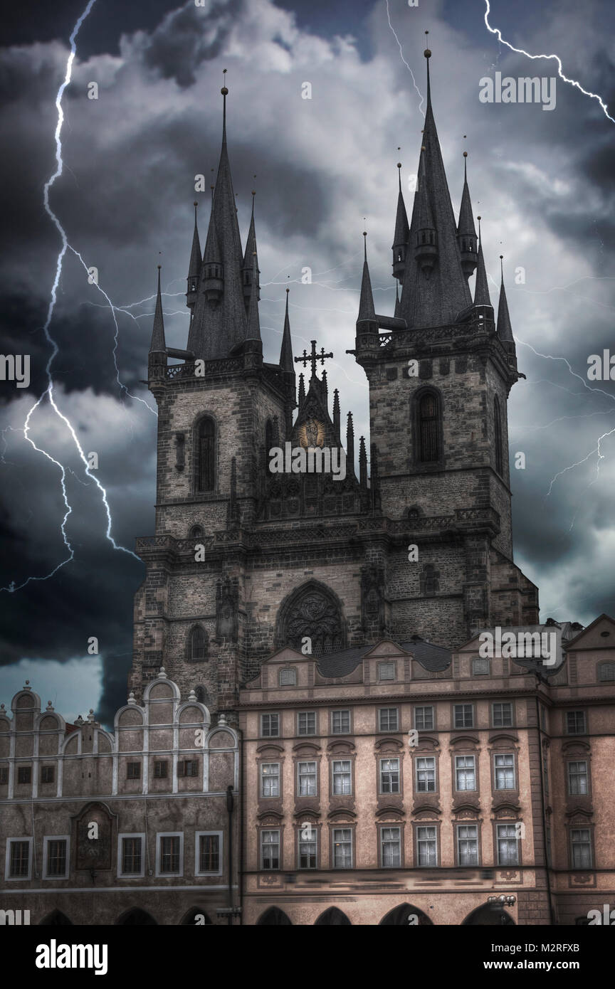 Heavy thunderstorm with lightning. Prague Old town square, Tyn Cathedral. under sunlight. Stock Photo