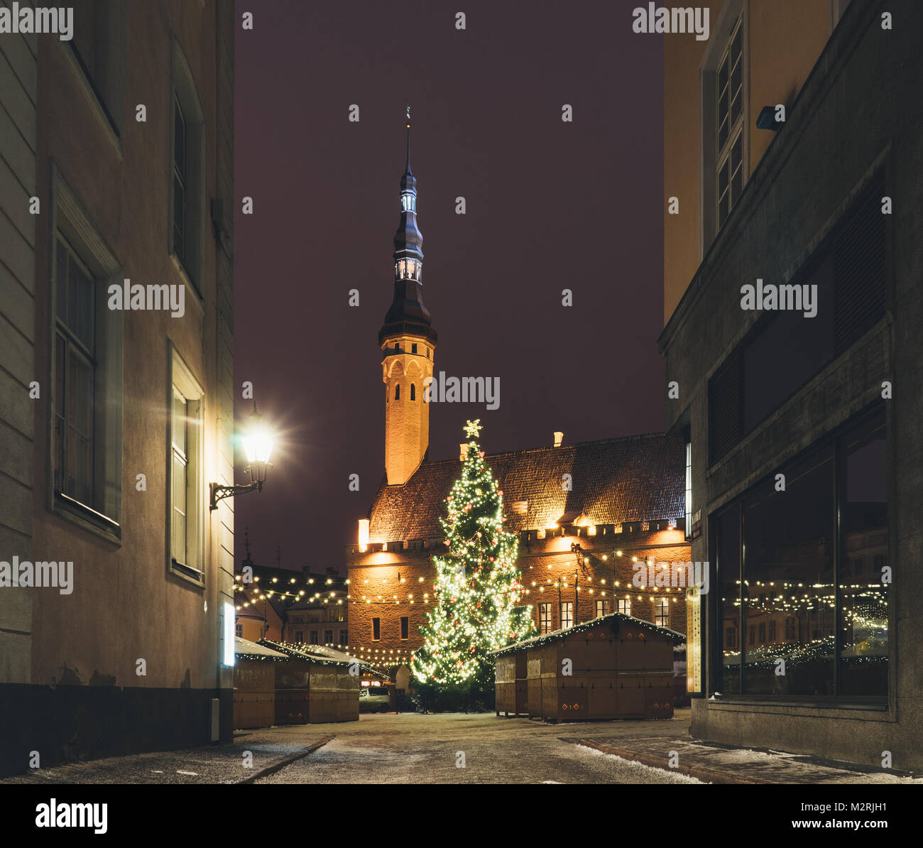 Traditional christmas market with illuminated and decorated fir on Town Hall Square. Old town, Tallinn, Estonia Stock Photo