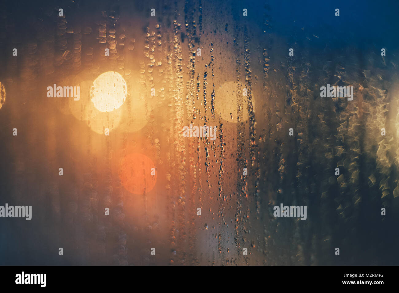 Rain drops on the window against bokeh lights. Shallow depth of field ...