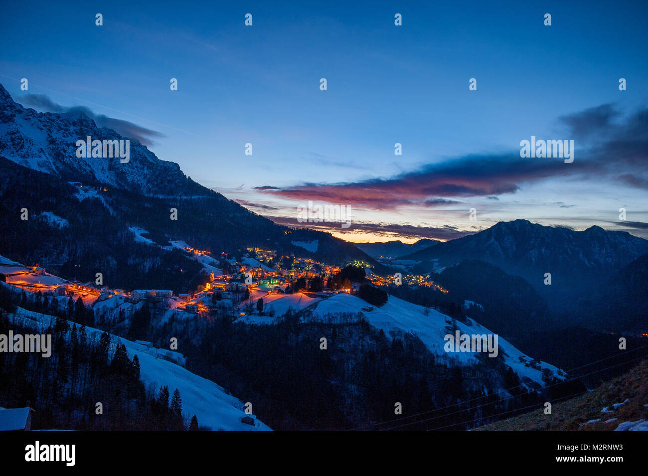 Snowy mountain village at sunset Stock Photo - Alamy