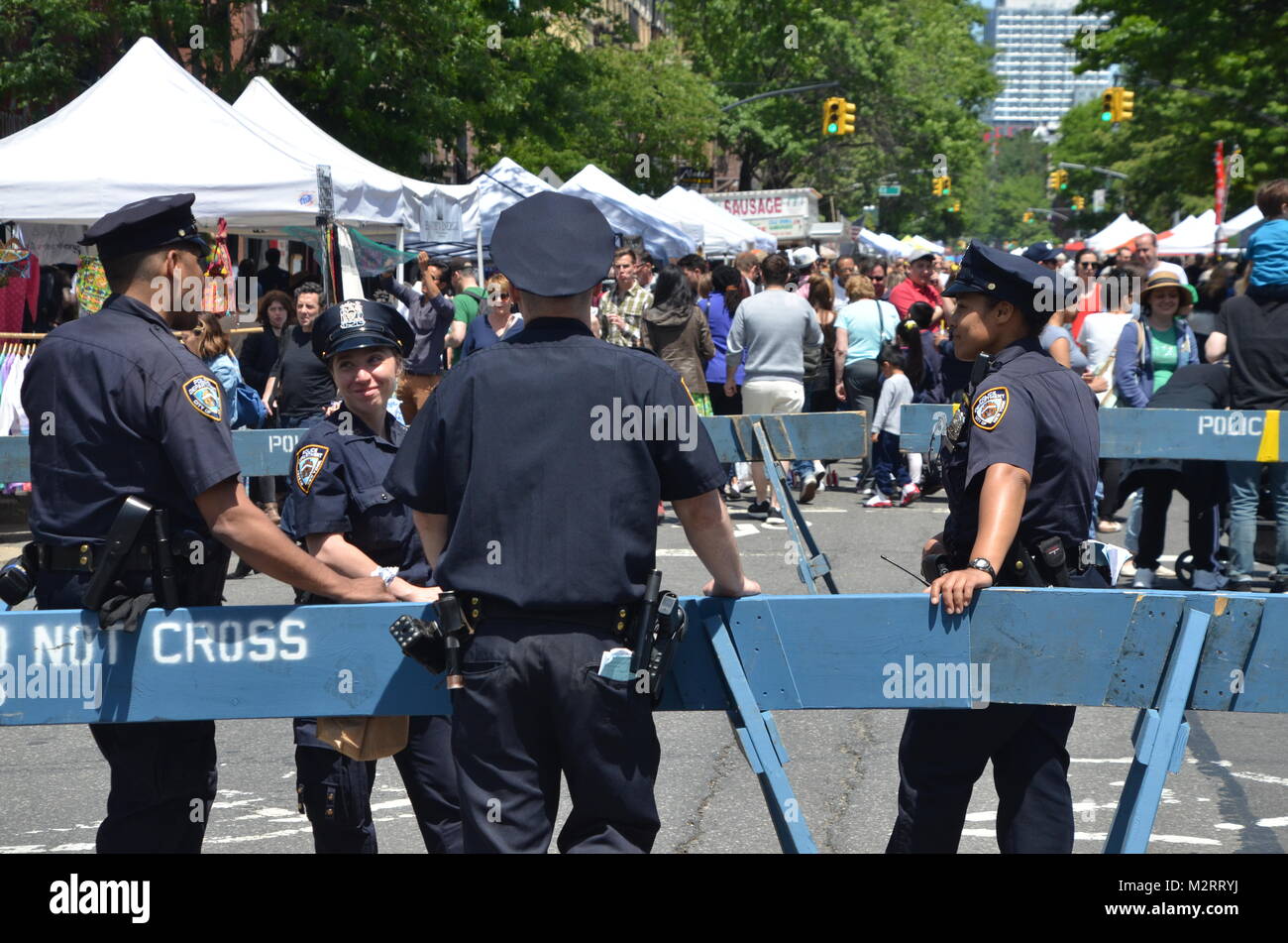 cops form the NYPD new york police department relax at a street fair in